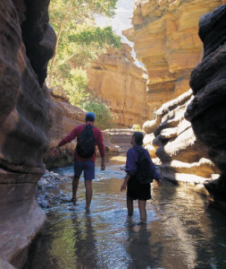 Two hikers in river-Cropped